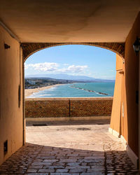 Scenic view of sea seen through archway