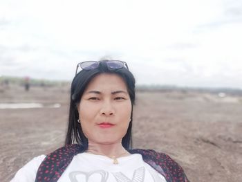 Portrait of young woman standing on beach