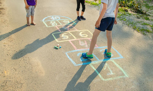 Low section of people walking on field