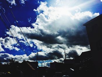 Low angle view of buildings against cloudy sky