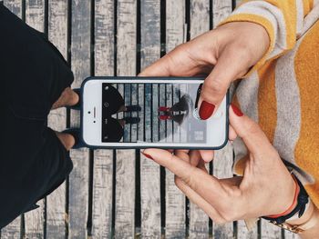 Midsection of man using mobile phone