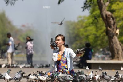 Woman kissing pigeon