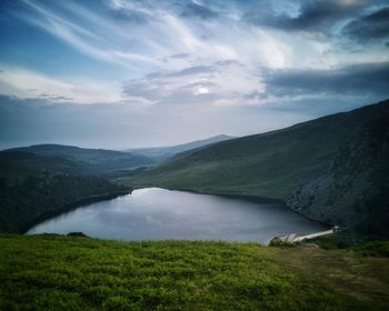 Scenic view of lake and mountains against sky