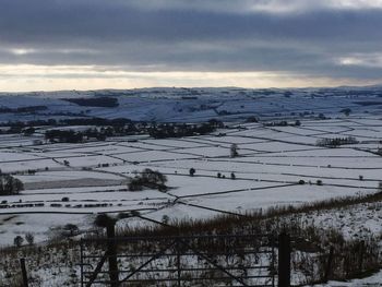 Scenic view of snow covered landscape against sky