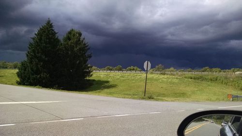 View of car on road against cloudy sky