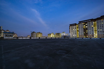 Illuminated buildings against sky at night