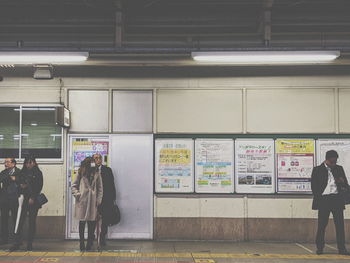 Rear view of people at railroad station