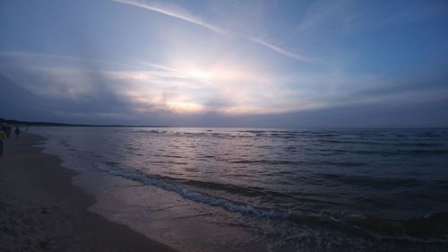 Scenic view of beach against sky during sunset