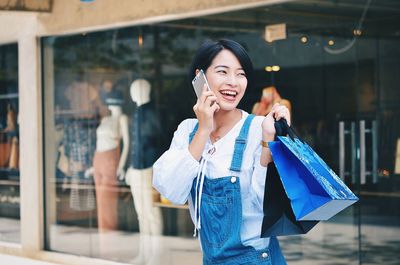 Portrait of smiling young woman standing outdoors