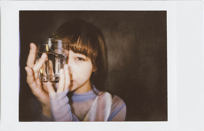 Portrait of boy holding camera