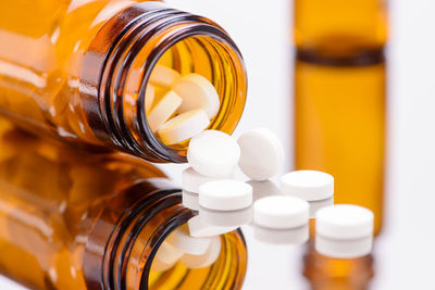 Close-up of container with pills on table