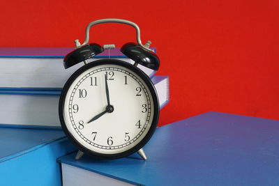 Close-up of alarm clock on yellow background