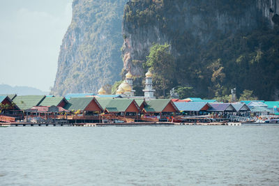 Scenic view of sea and buildings against sky