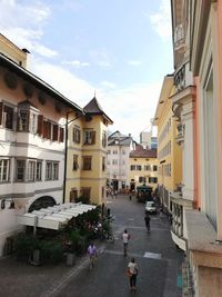 People on street amidst buildings in town