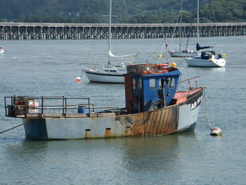 Boats moored in sea against sky