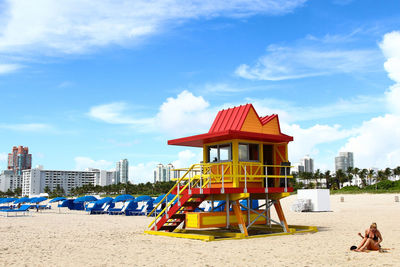 Lifeguard hut on beach against sky in city