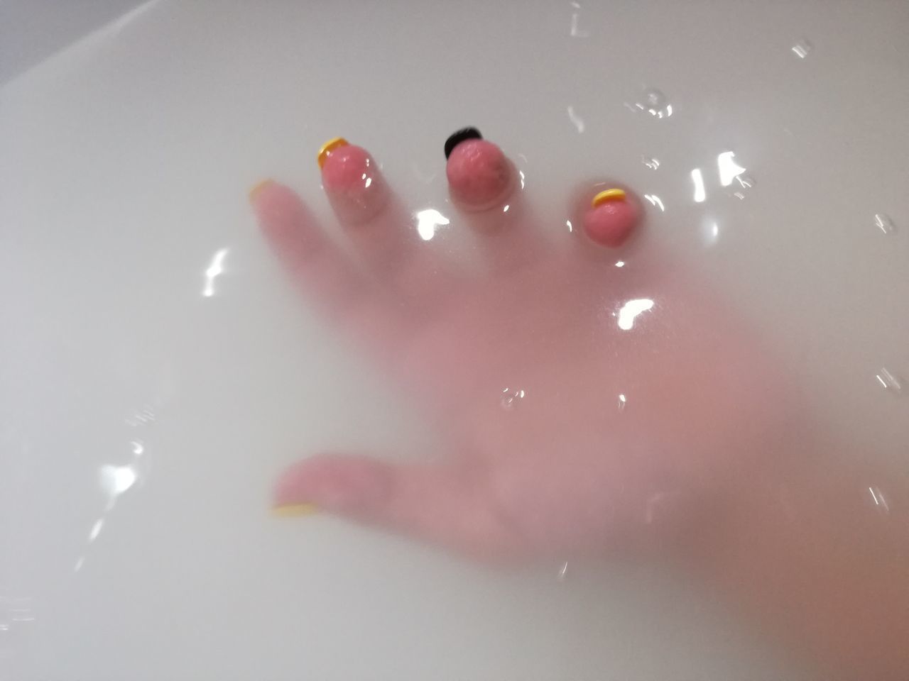 CLOSE-UP OF HANDS ON WATER