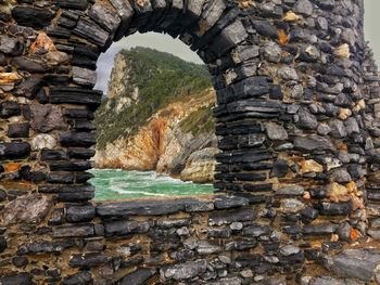 View of stone wall through rocks