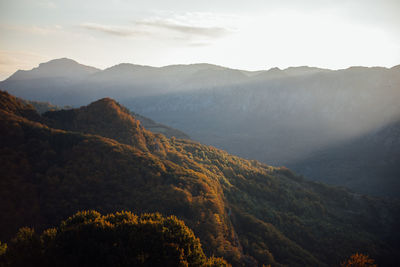 Scenic view of mountains against sky at sunset. captured from above with drone