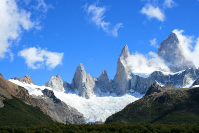 Scenic view of snowcapped mountains against cloudy sky