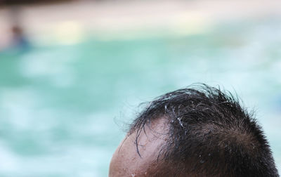 Close-up of man with receding hairline outdoors
