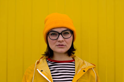 Portrait of mid adult man against yellow wall