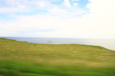 Scenic view of sea and landscape against sky