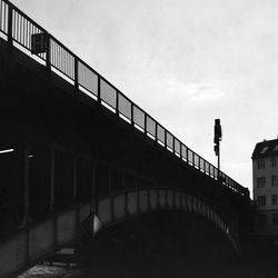 Staircase by bridge against sky