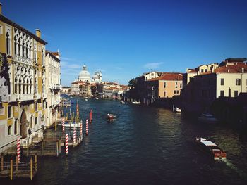 Boats in canal with buildings in background