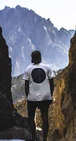 Rear view of man standing on mountain