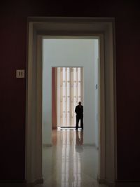 Rear view of man walking in building