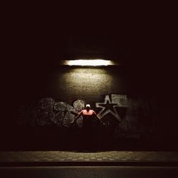 Woman standing in tunnel