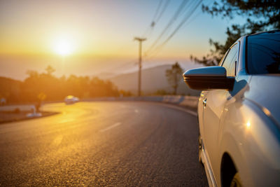 Car for traveling on a mountain road in the morning sun rise