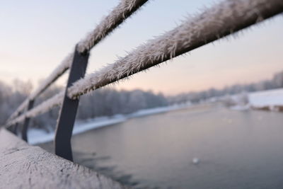 Close-up of frozen water in lake against sky