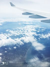 Cropped image of airplane flying over landscape