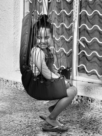 Side view of girl sitting on swing