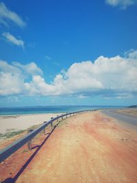 Scenic view of beach against blue sky