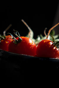 Close-up of cherries against black background