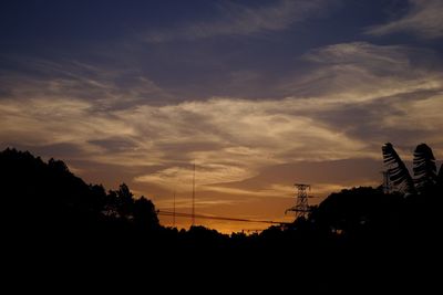 Silhouette of tree against cloudy sky