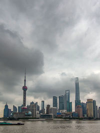 Cityscape against cloudy sky