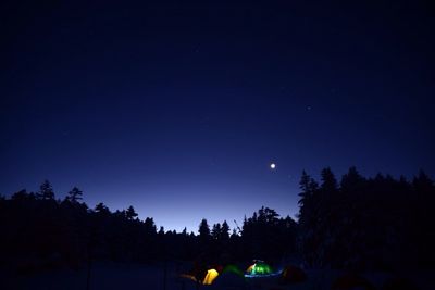 Low angle view of moon against blue sky