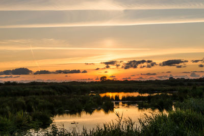 Scenic view of lake against sky during sunset