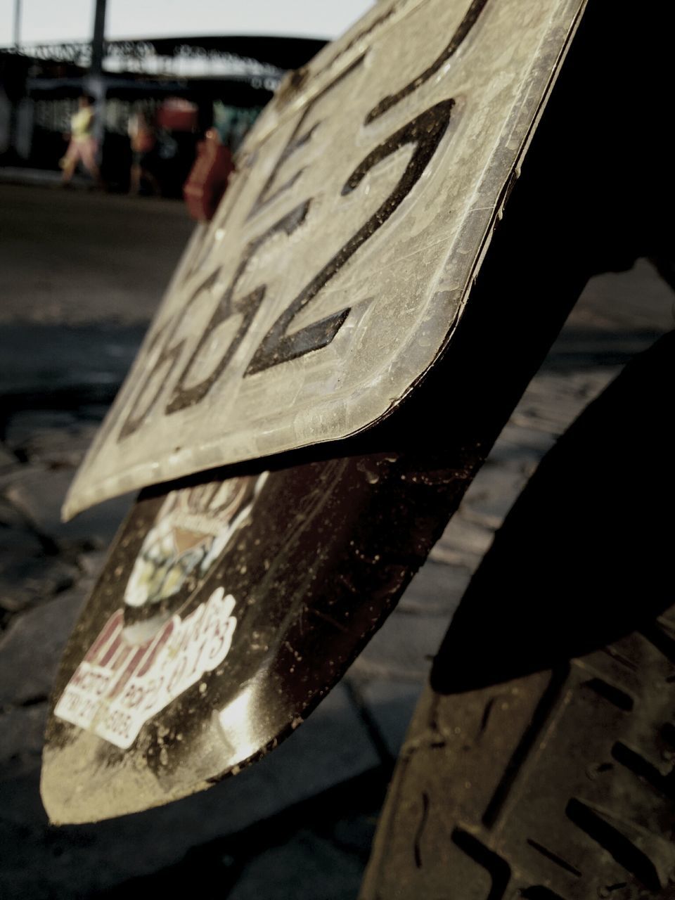 focus on foreground, close-up, wood - material, table, outdoors, no people, day, wooden, selective focus, still life, bench, sunlight, wood, street, high angle view, absence, cropped, part of, incidental people, empty