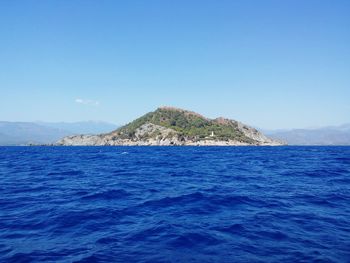 Scenic view of sea against clear blue sky