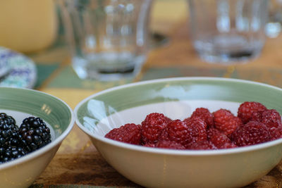 Close-up of strawberries in glass bowl on table