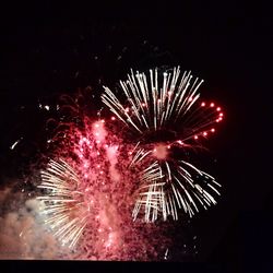 Low angle view of firework display at night