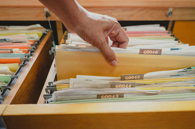 Cropped image of person reading book