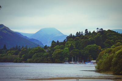 Scenic view of sea and mountains against sky
