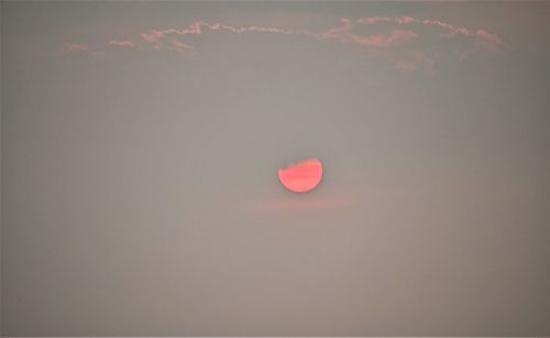 Low angle view of red moon in sky