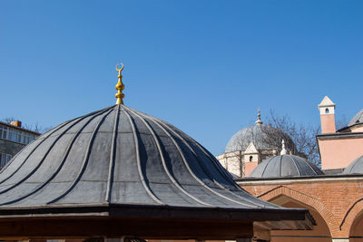 Panoramic view of temple building against clear blue sky